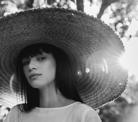woman in white crew neck shirt wearing brown sun hat