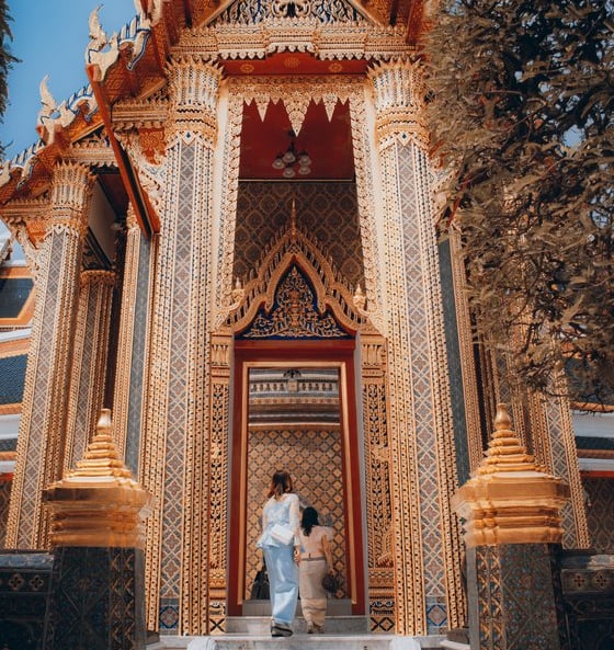 man and woman standing in front of brown concrete building during daytime