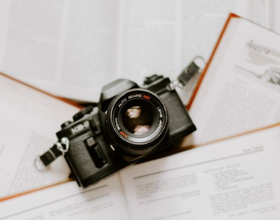 black nikon dslr camera on white printer paper