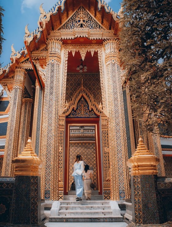man and woman standing in front of brown concrete building during daytime