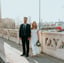 man in black suit standing beside woman in white wedding dress