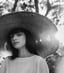 woman in white crew neck shirt wearing brown sun hat