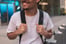 man in white crew neck t-shirt wearing blue cap and black sunglasses