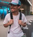 man in white crew neck t-shirt wearing blue cap and black sunglasses