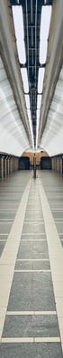 man in black jacket walking on hallway