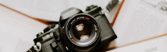 black nikon dslr camera on white printer paper