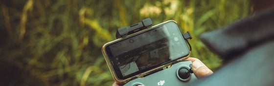 person holding black and gray digital camera