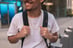 man in white crew neck t-shirt wearing blue cap and black sunglasses