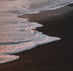 ocean waves crashing on shore during daytime