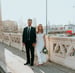 man in black suit standing beside woman in white wedding dress