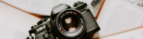 black nikon dslr camera on white printer paper