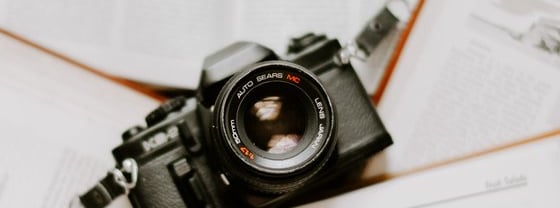 black nikon dslr camera on white printer paper