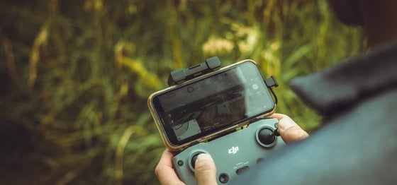 person holding black and gray digital camera