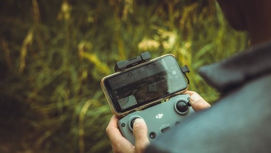 person holding black and gray digital camera