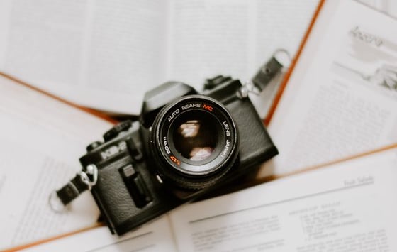 black nikon dslr camera on white printer paper