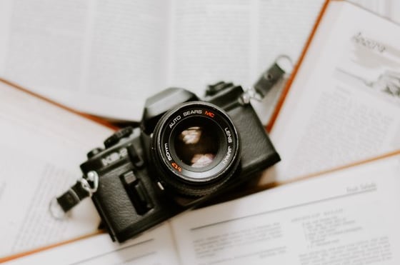 black nikon dslr camera on white printer paper