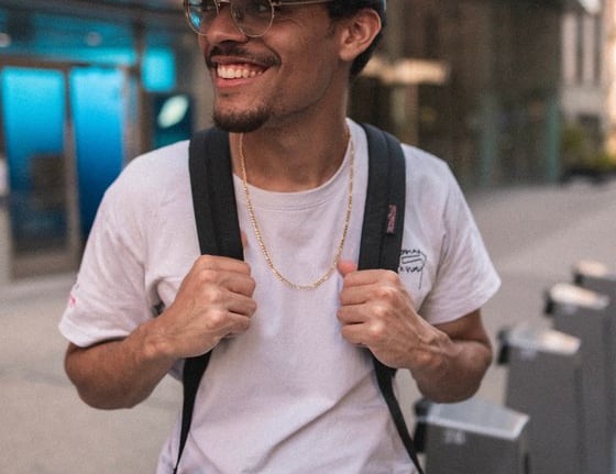 man in white crew neck t-shirt wearing blue cap and black sunglasses
