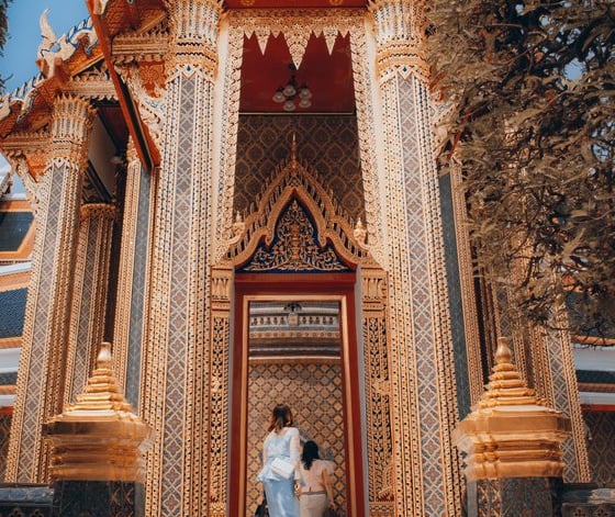 man and woman standing in front of brown concrete building during daytime