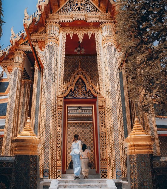 man and woman standing in front of brown concrete building during daytime