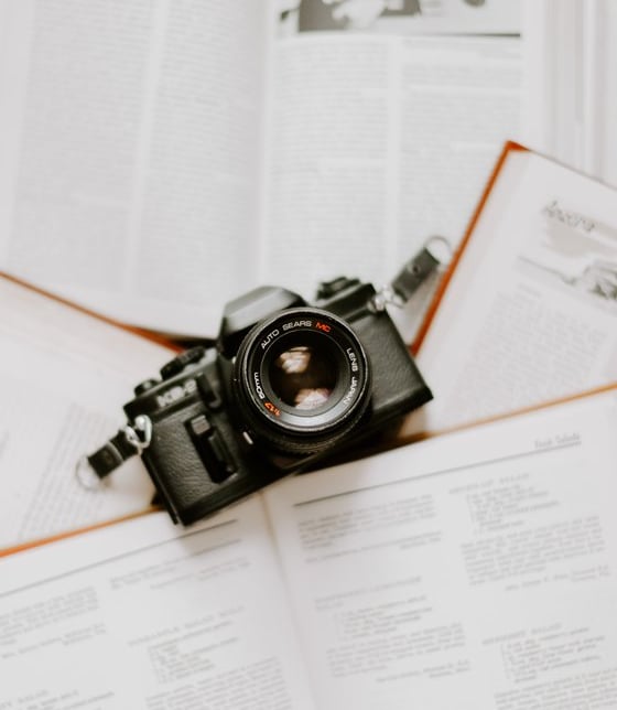 black nikon dslr camera on white printer paper