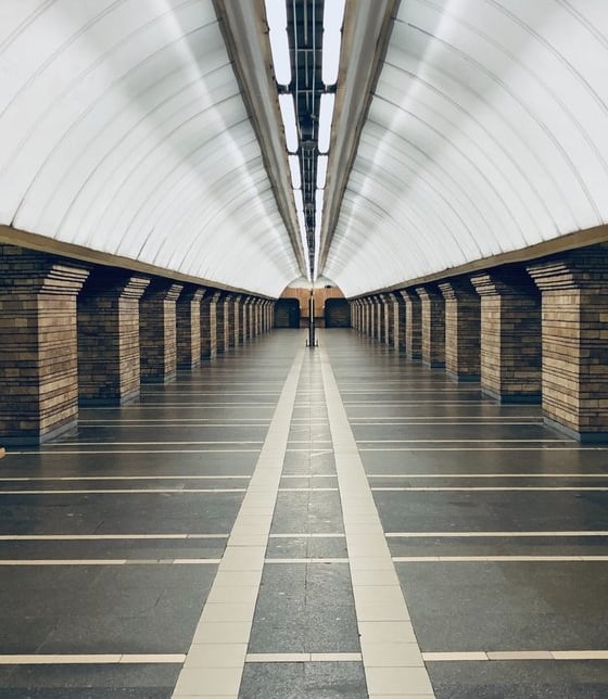 man in black jacket walking on hallway