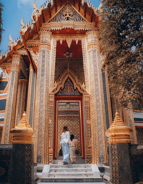 man and woman standing in front of brown concrete building during daytime
