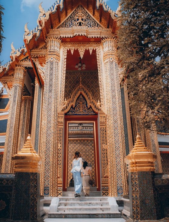 man and woman standing in front of brown concrete building during daytime