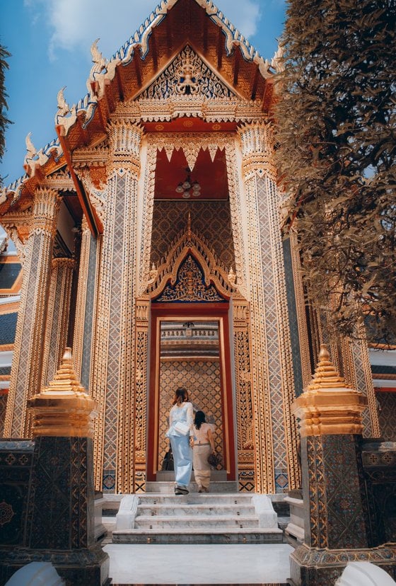 man and woman standing in front of brown concrete building during daytime