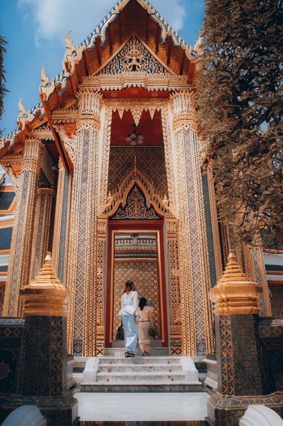 man and woman standing in front of brown concrete building during daytime