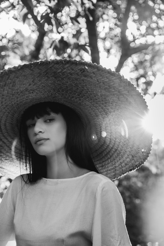 woman in white crew neck shirt wearing brown sun hat