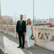 man in black suit standing beside woman in white wedding dress