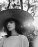 woman in white crew neck shirt wearing brown sun hat