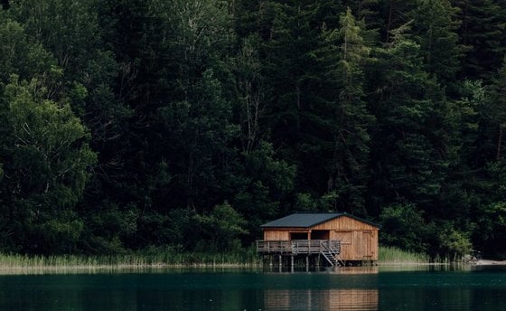 brown wooden house on lake
