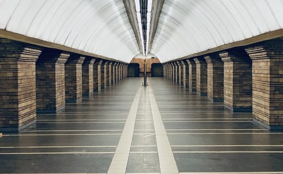 man in black jacket walking on hallway