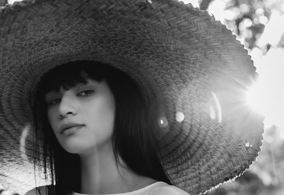 woman in white crew neck shirt wearing brown sun hat