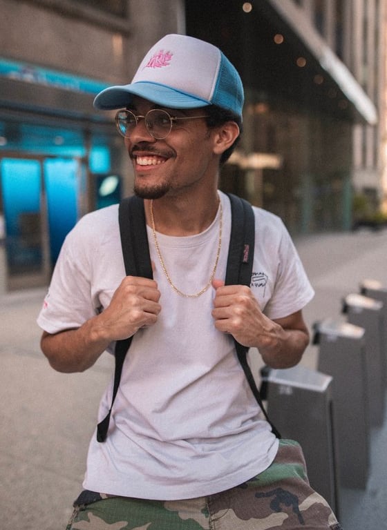 man in white crew neck t-shirt wearing blue cap and black sunglasses