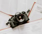 black nikon dslr camera on white printer paper