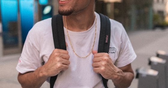 man in white crew neck t-shirt wearing blue cap and black sunglasses