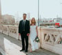 man in black suit standing beside woman in white wedding dress
