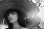 woman in white crew neck shirt wearing brown sun hat