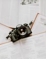 black nikon dslr camera on white printer paper