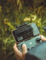 person holding black and gray digital camera