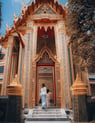man and woman standing in front of brown concrete building during daytime