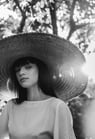 woman in white crew neck shirt wearing brown sun hat