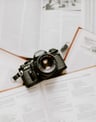 black nikon dslr camera on white printer paper