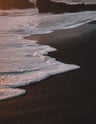 ocean waves crashing on shore during daytime