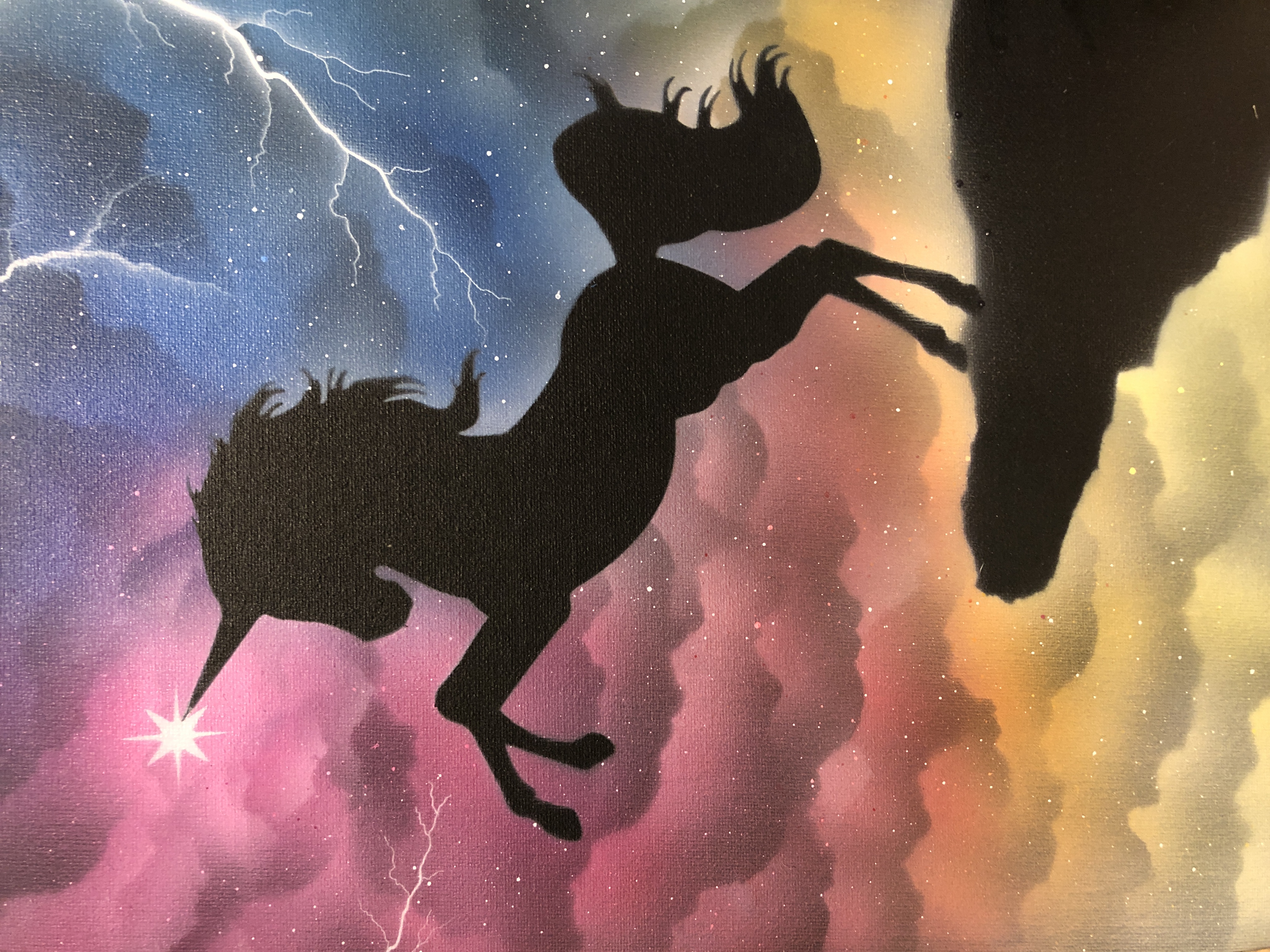 Unicorn with colored clouds background
