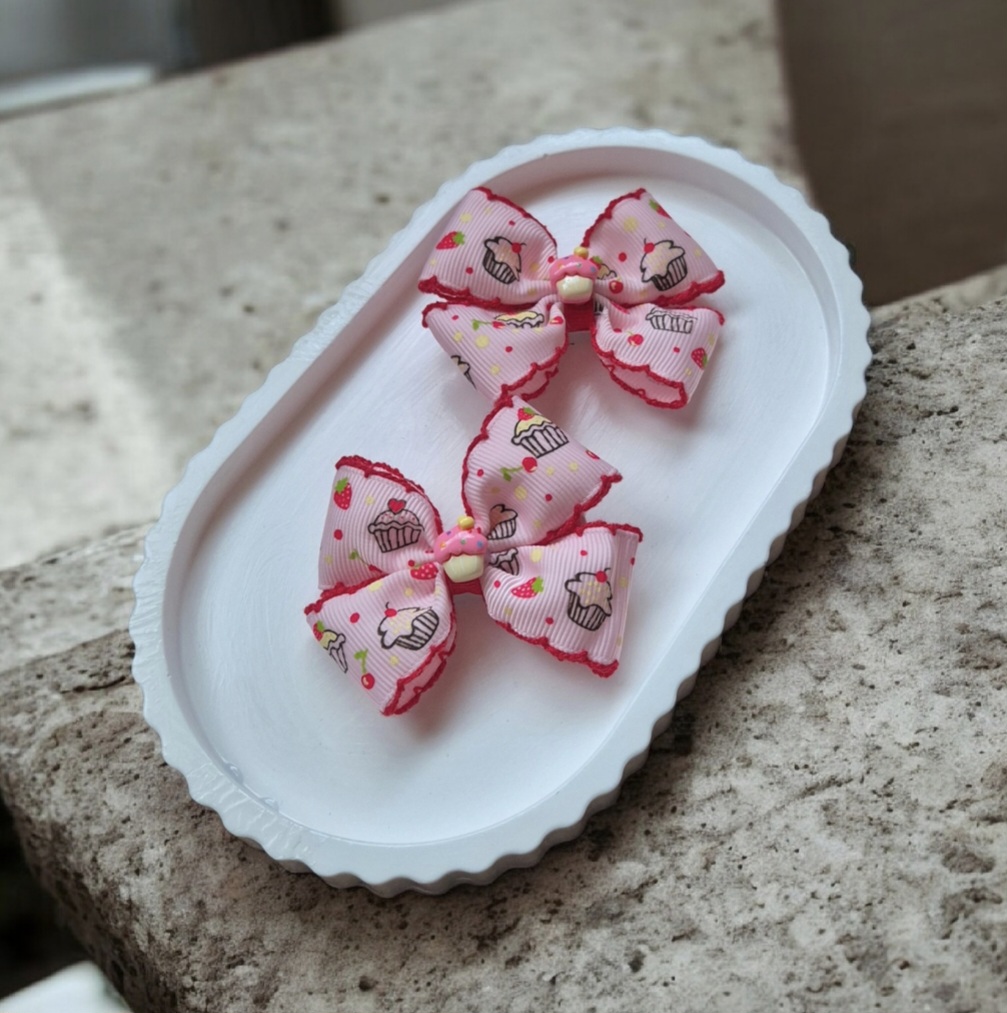 Vaikiški plaukų segtukai ir gumytės su rožiniais keksiukų kaspinėliais – žaismingi aksesuarai mergaitėms