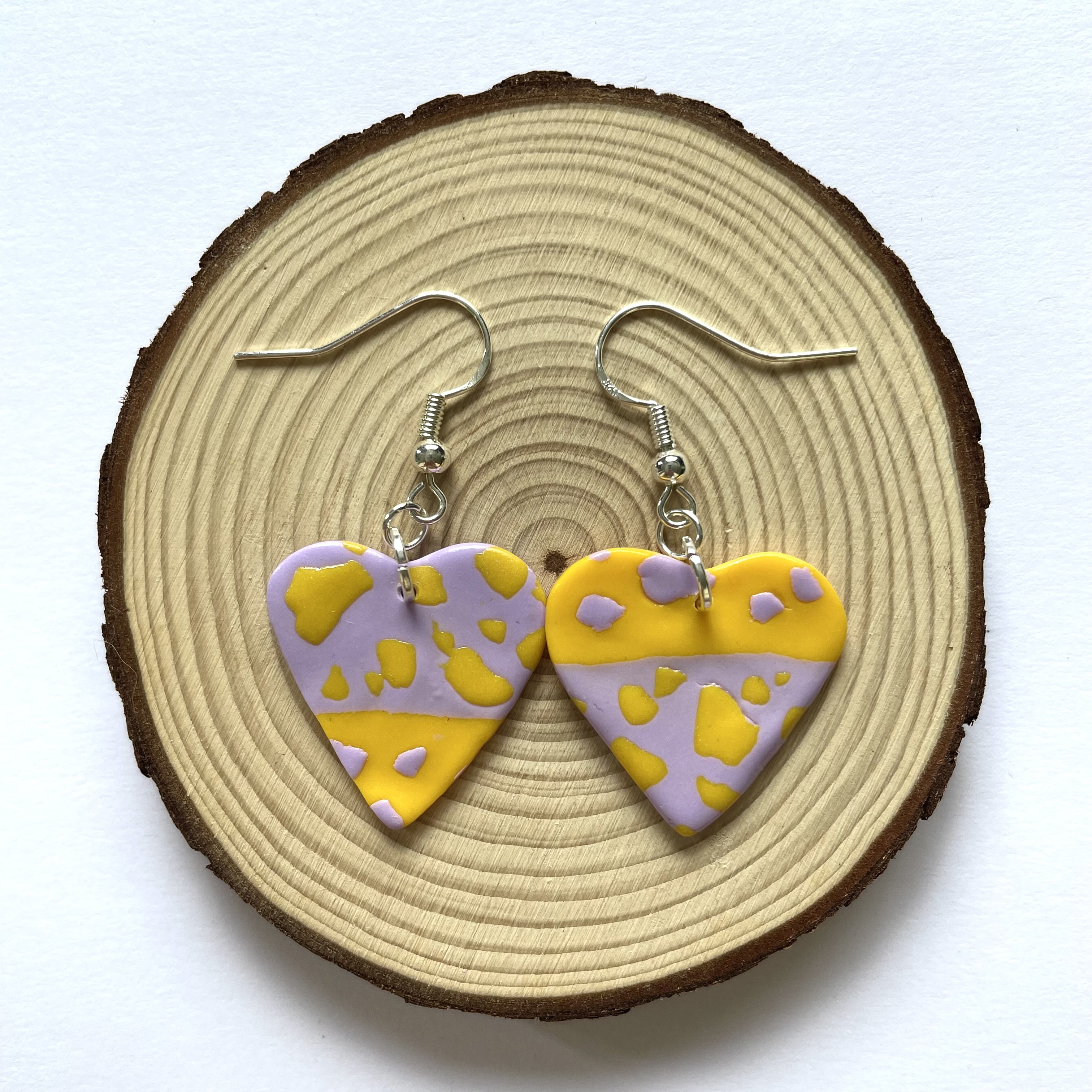yellow + purple cow print heart earrings
