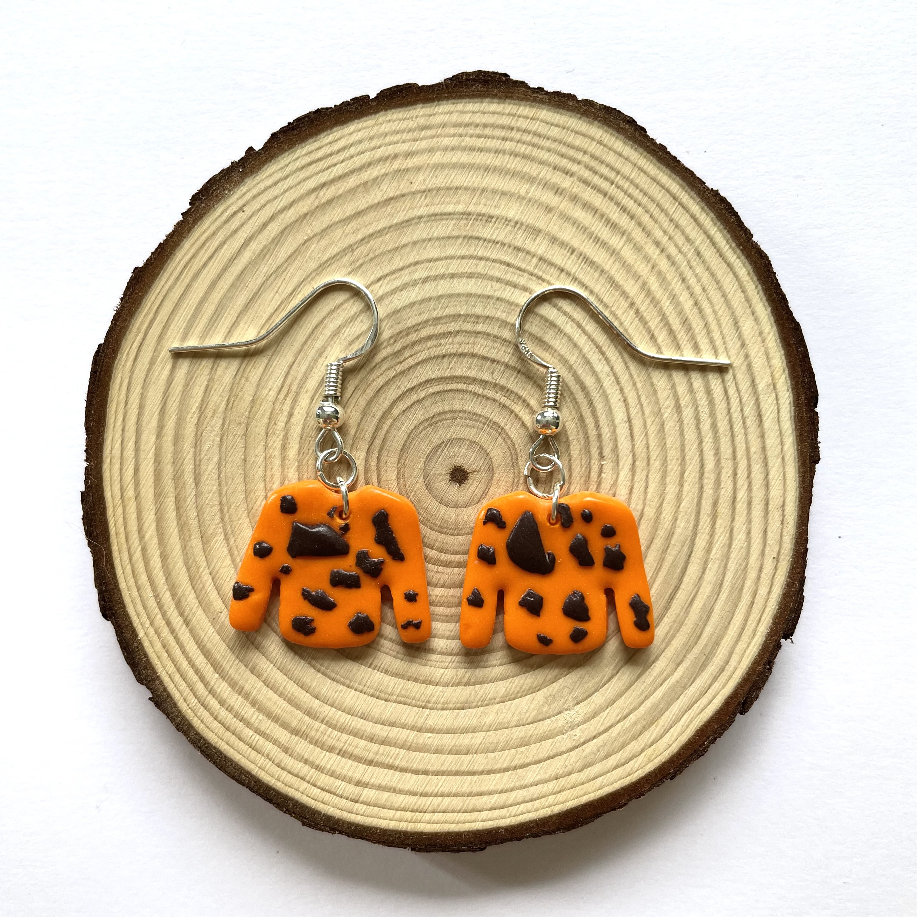 orange jumper earrings